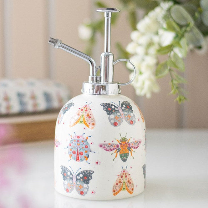 Ceramic plant mister with a bug-illustration motif and silver-effect spray pump.