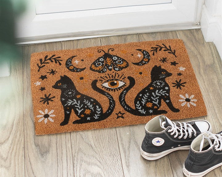 Natural decorative doormat with a gothic folk-inspired design, including black cats, moth, crescent moons and vintage fauna.