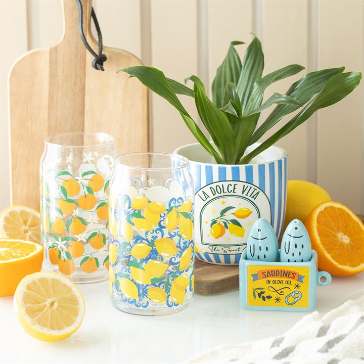 Sardine shaped salt and pepper shaker set presented in a sardine-can holder. Presented alongside other items from the same range.