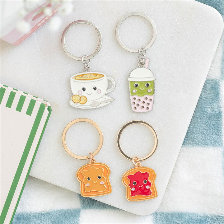 Kawaii style matcha bubble tea enamel keyring. Presented alongside other items from the same range. 