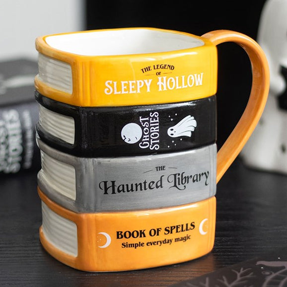 Halloween themed ceramic mug, designed to resemble a stack of ghost stories and spell books. 
