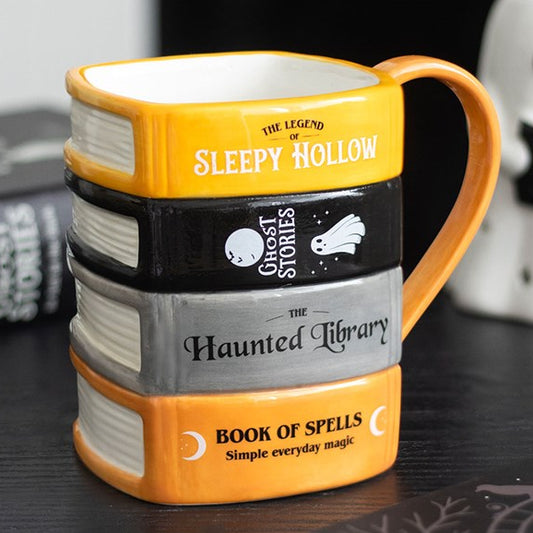 Halloween themed ceramic mug, designed to resemble a stack of ghost stories and spell books. 