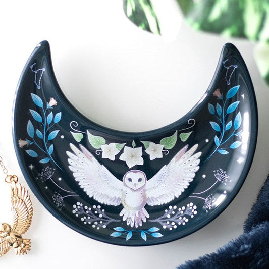 Vintage design trinket dish. Shaped like a crescent moon and depicting a midnight owl in full flight, this trinket dish is finished with forest fauna accents on a dark background. 