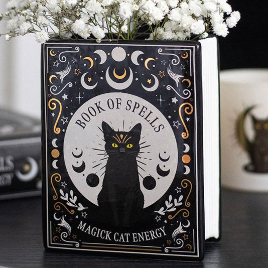 Black book shaped vase with gothic-inspired black cat celestial design and 'Book of Spells I Magick Cat Energy' text.