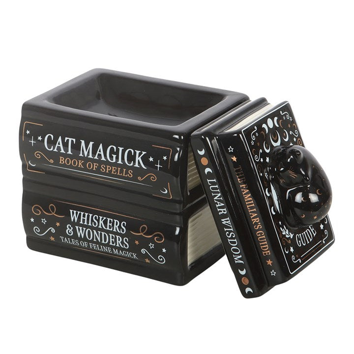 Wax melter and oil burner shaped like a stack of gothic books with a sleeping-cat detailed lid. 