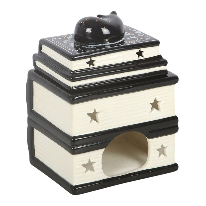 Wax melter and oil burner shaped like a stack of gothic books with a sleeping-cat detailed lid. Reverse view.
