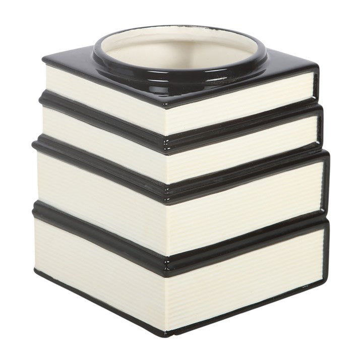 A black gothic themed flower vase, resembling a stack of spell and celestial books.