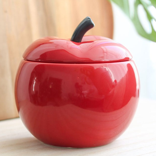 Ceramic wax melter and oil burner shaped like a red apple, with removable lid. 