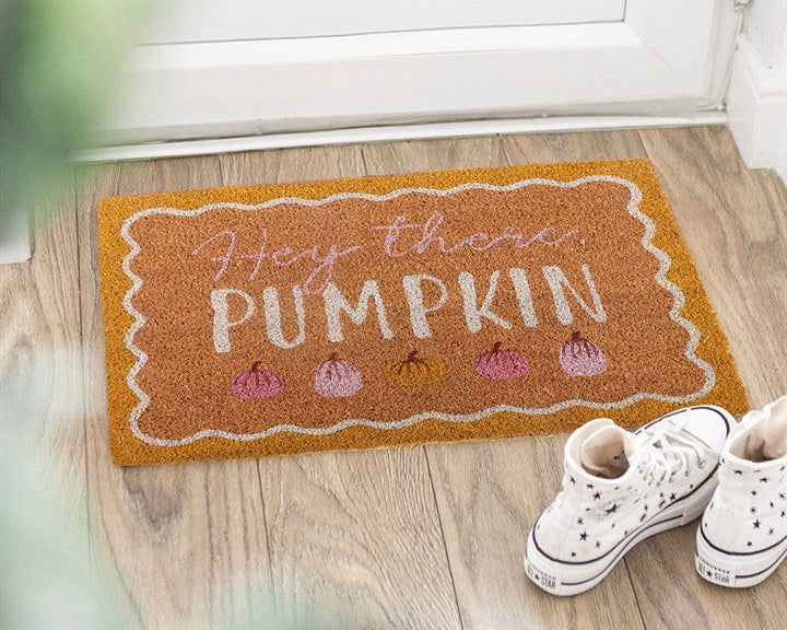 Decorative natural doormat with a display of colourful pumpkins, a scalloped border and 'Hey There Pumpkin' text.