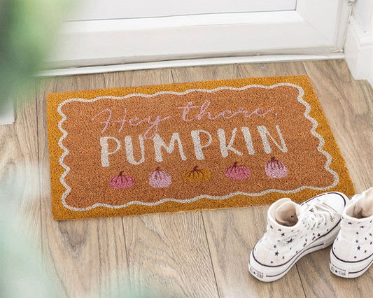 Decorative natural doormat with a display of colourful pumpkins, a scalloped border and 'Hey There Pumpkin' text.