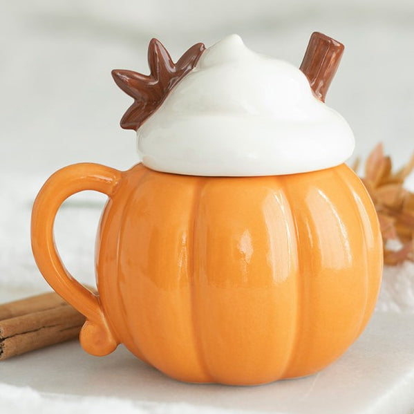 Pumpkin shaped mug with a whipped cream shaped lid, finished with cinnamon embellishment.