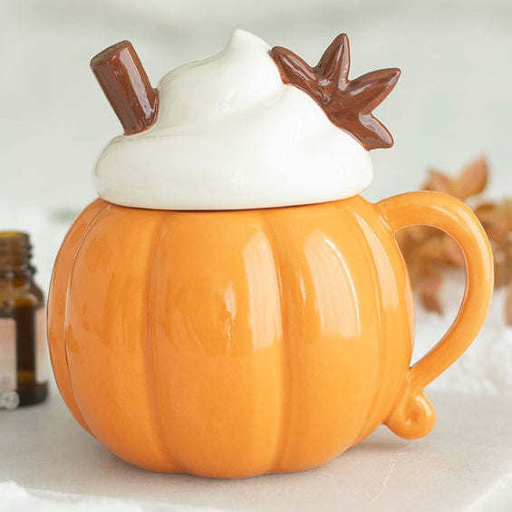 Ceramic wax melter and oil burner shaped like a pumpkin-shaped mug with a whipped cream and cinnamon shaped lid.