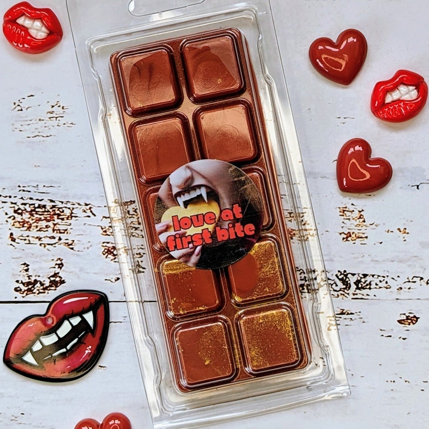 Love At First Bite coconut wax melt. Deep red snap bar with golden shimmer accents.