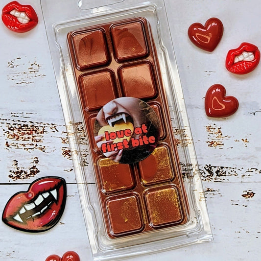 Love At First Bite coconut wax melt. Deep red snap bar with golden shimmer accents.