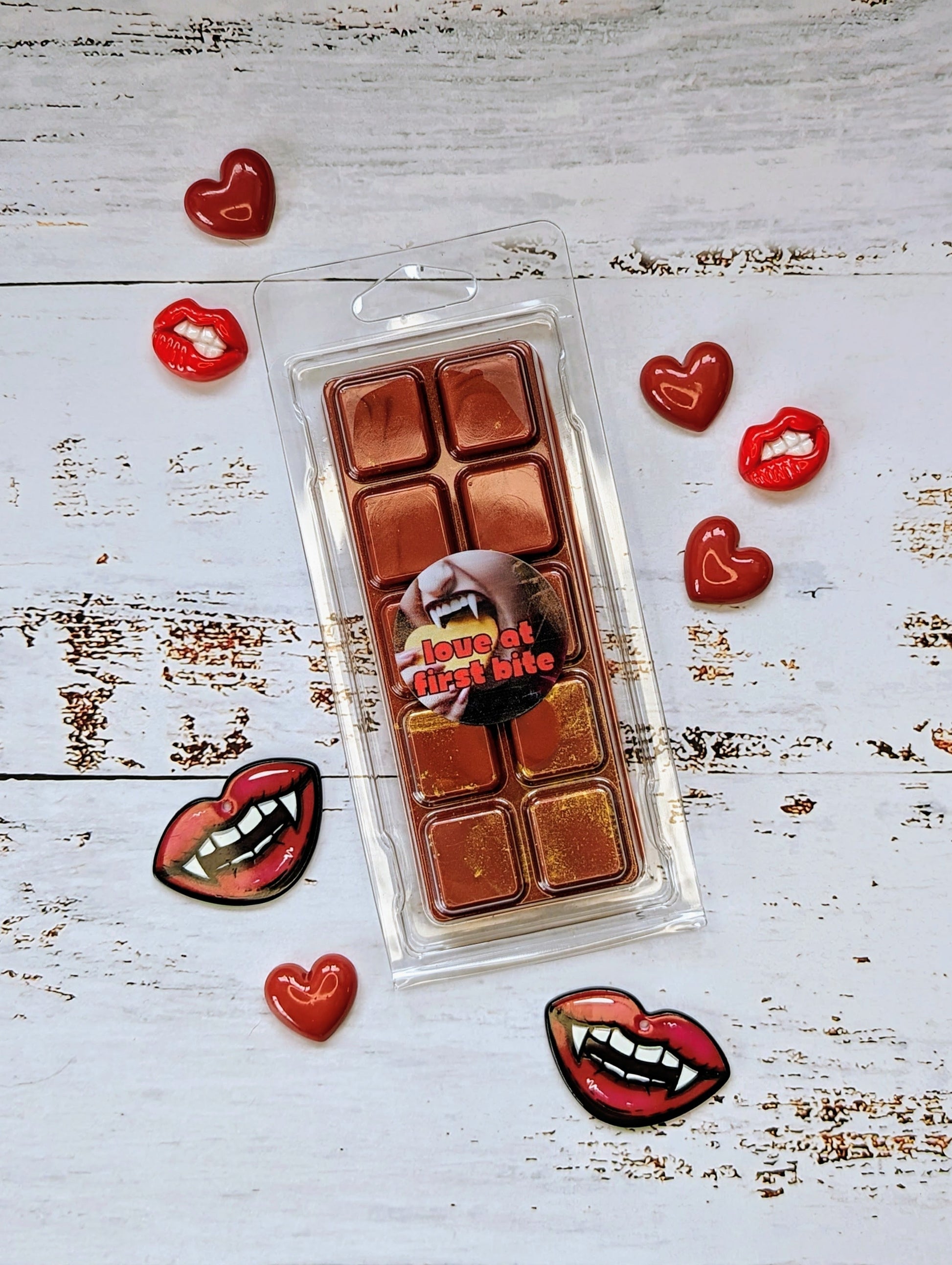 Love At First Bite coconut wax melt. Deep red snap bar with golden shimmer accents.