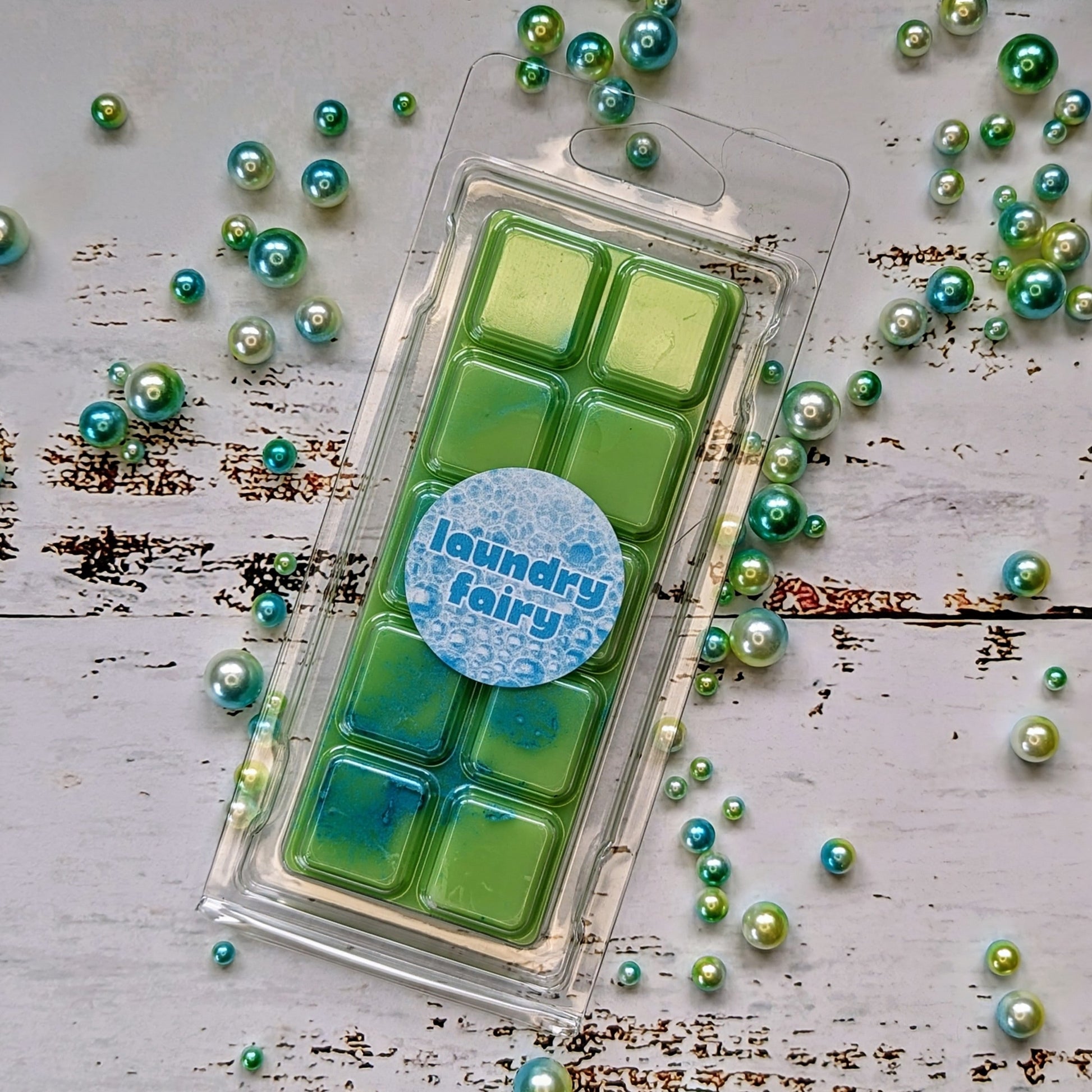 Laundry Fairy coconut wax melt. Light green snap bar with blue and green shimmer accents. 