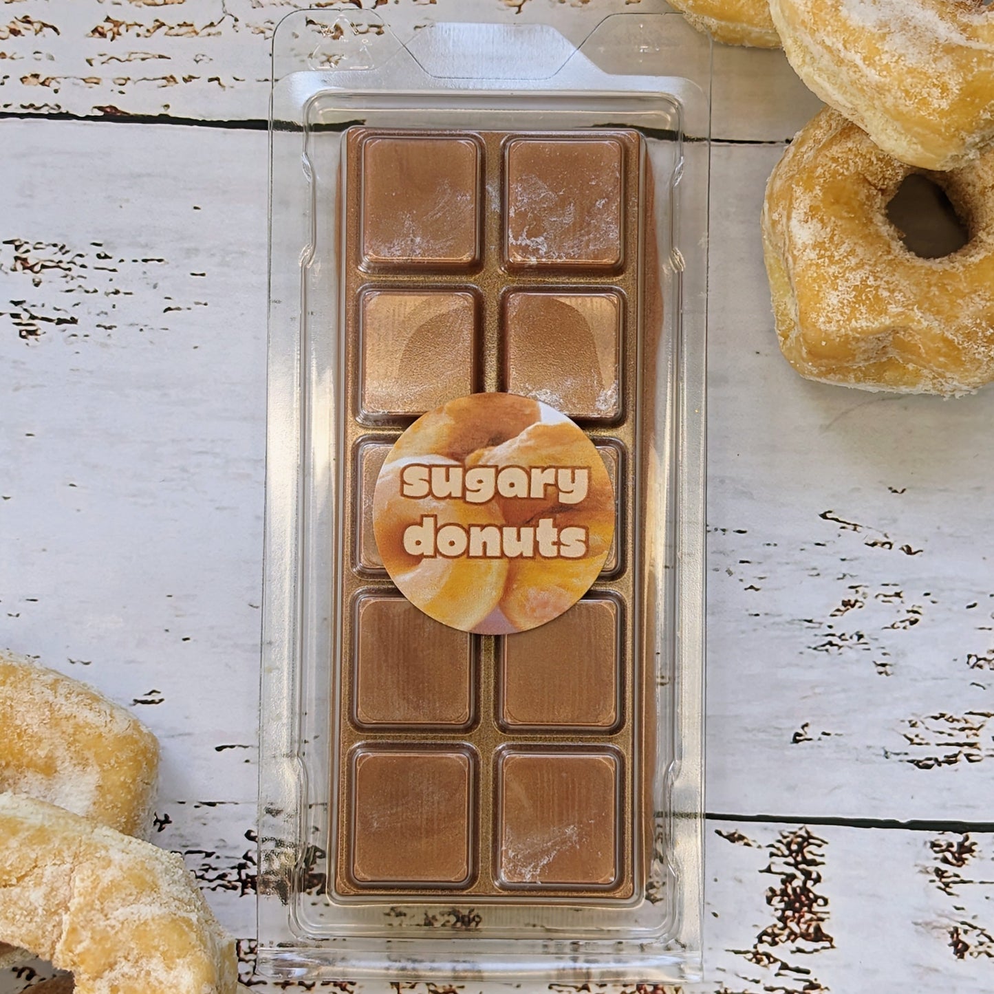 Sugary donuts coconut wax melt. Light brown snap bar with silver shimmery accents.