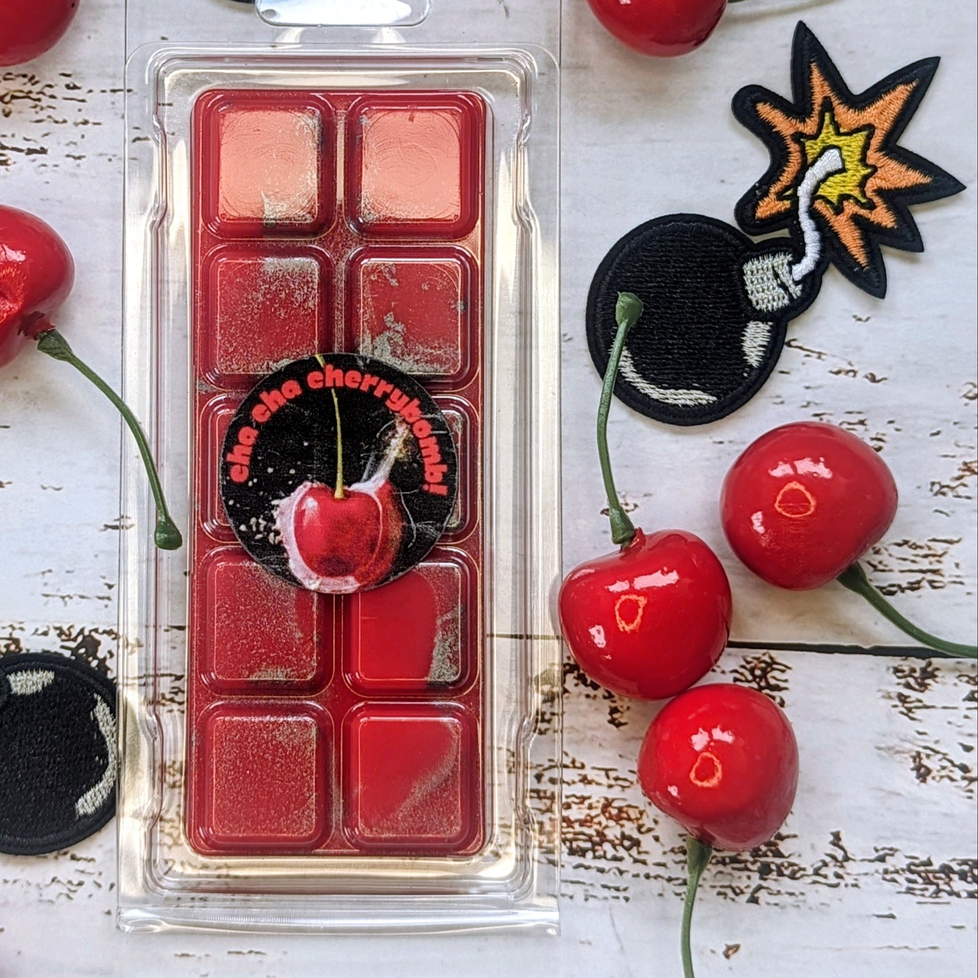 Cha Cha Cherrybomb! coconut wax melt. Bright red snap bar with silver metallic shimmer accents. 