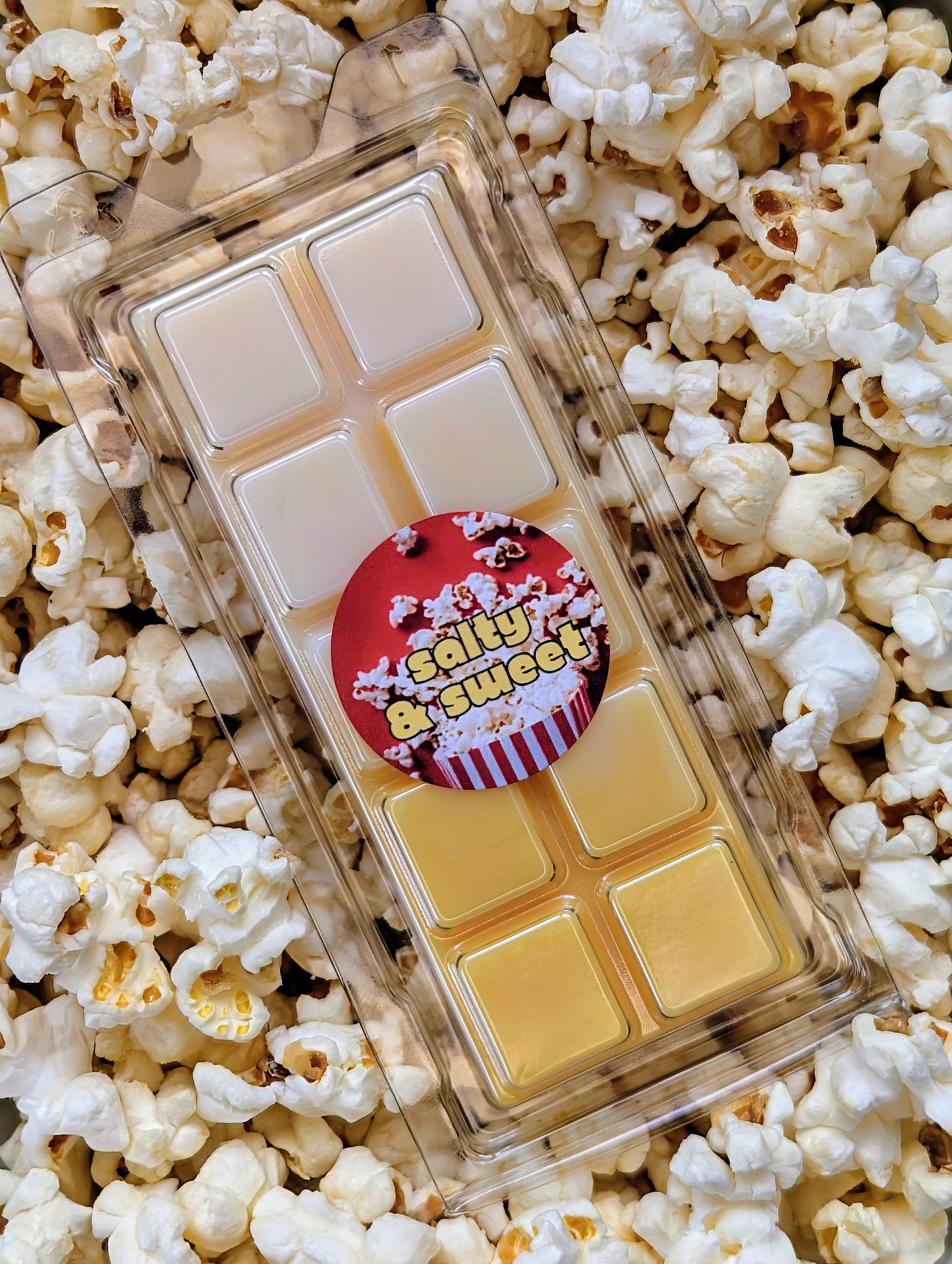 Salty and sweet popcorn coconut wax melt. Light and dark yellow ombre snap bar with orange shimmer accents. 