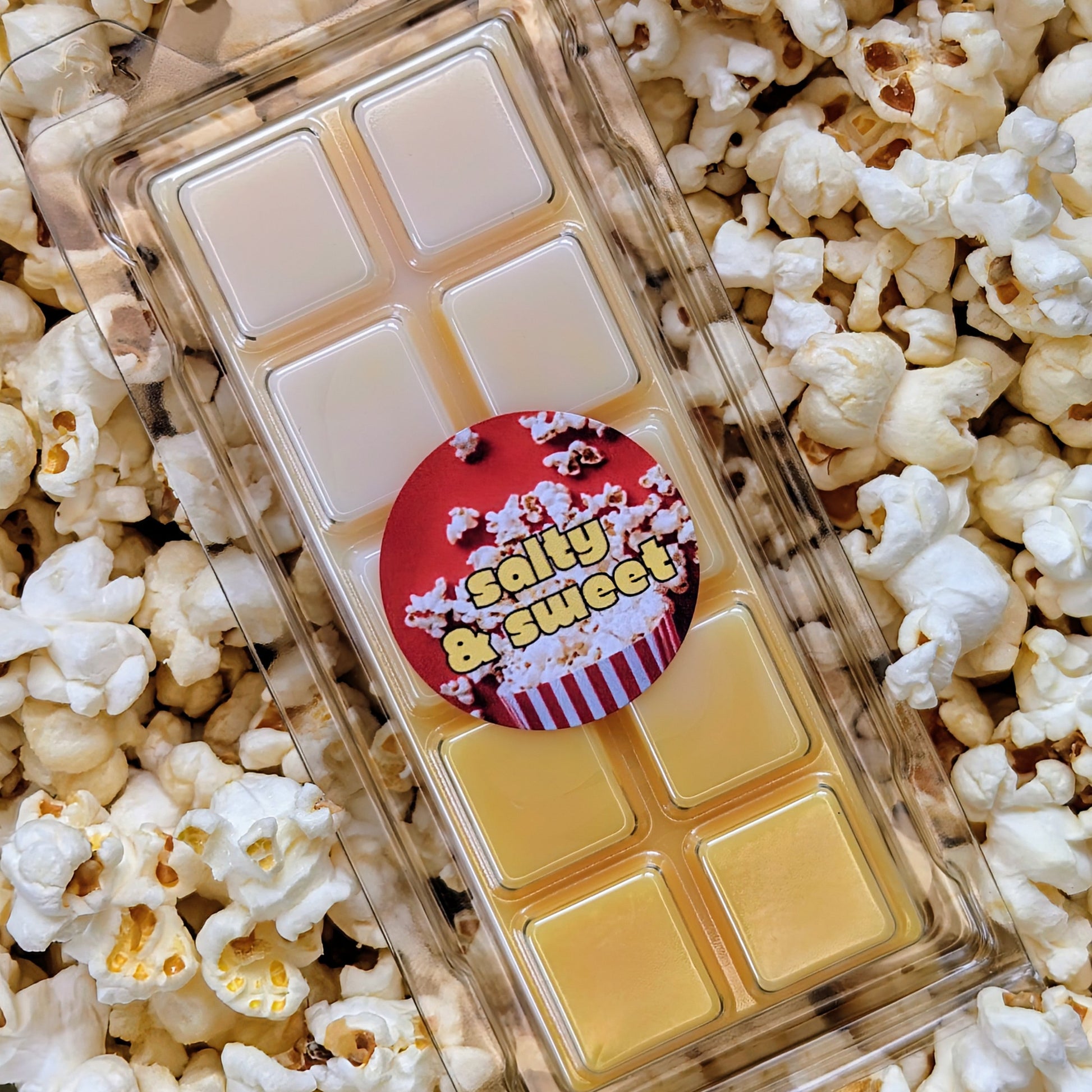 Salty and sweet popcorn coconut wax melt. Light and dark yellow ombre snap bar with orange shimmer accents. 