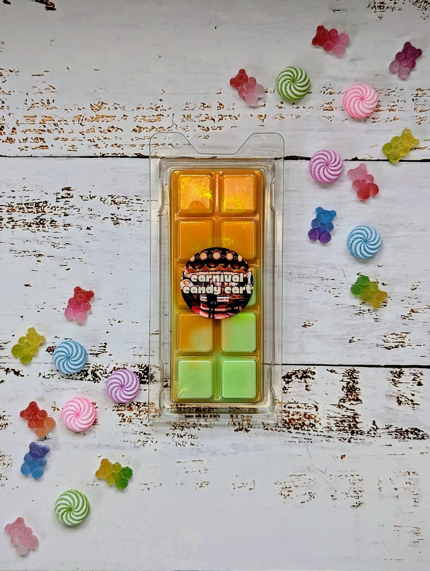 Carnival Candy Cart coconut wax melt. Light orange and light green ombre snap bar with golden shimmer accents.