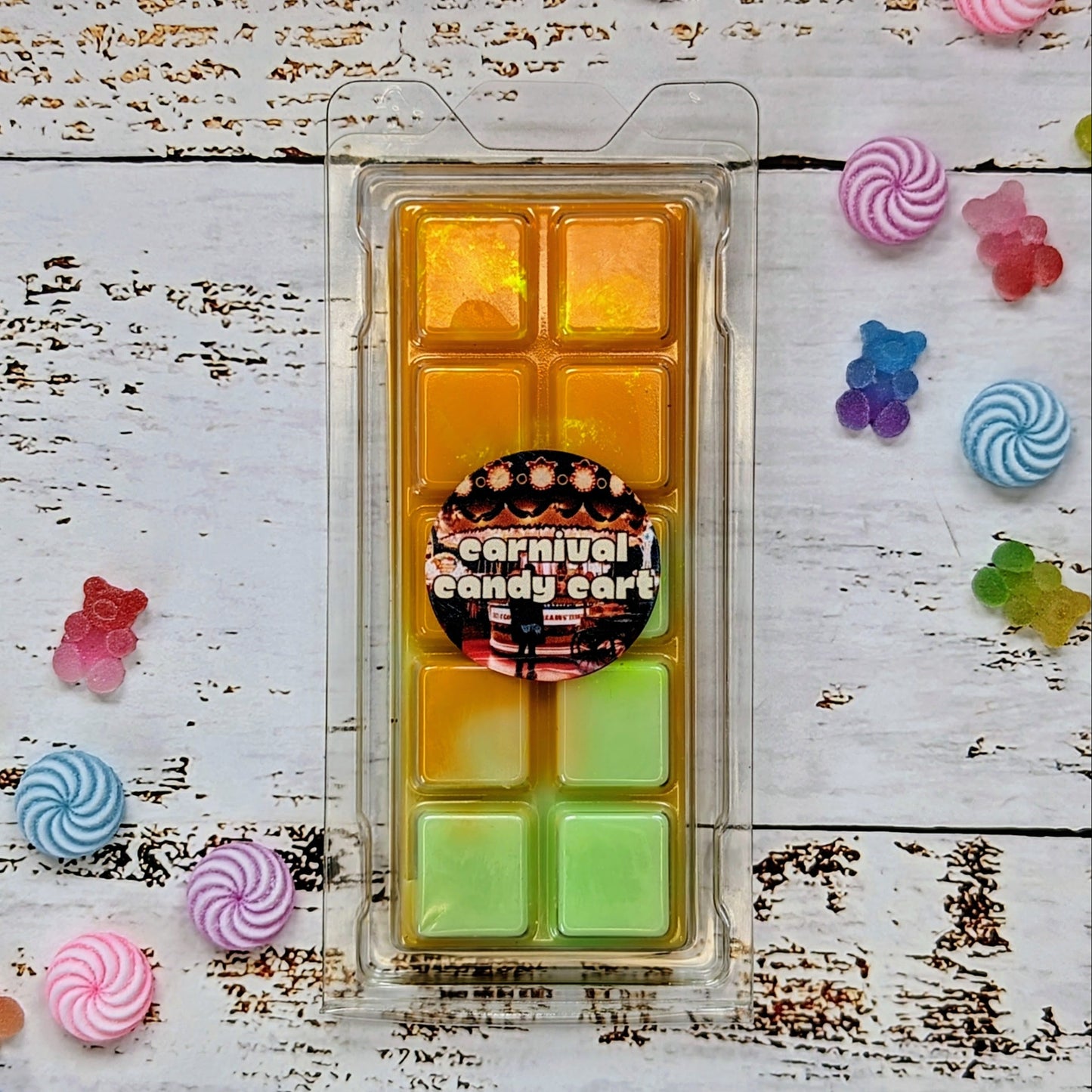 Carnival Candy Cart coconut wax melt. Light orange and light green ombre snap bar with golden shimmer accents.
