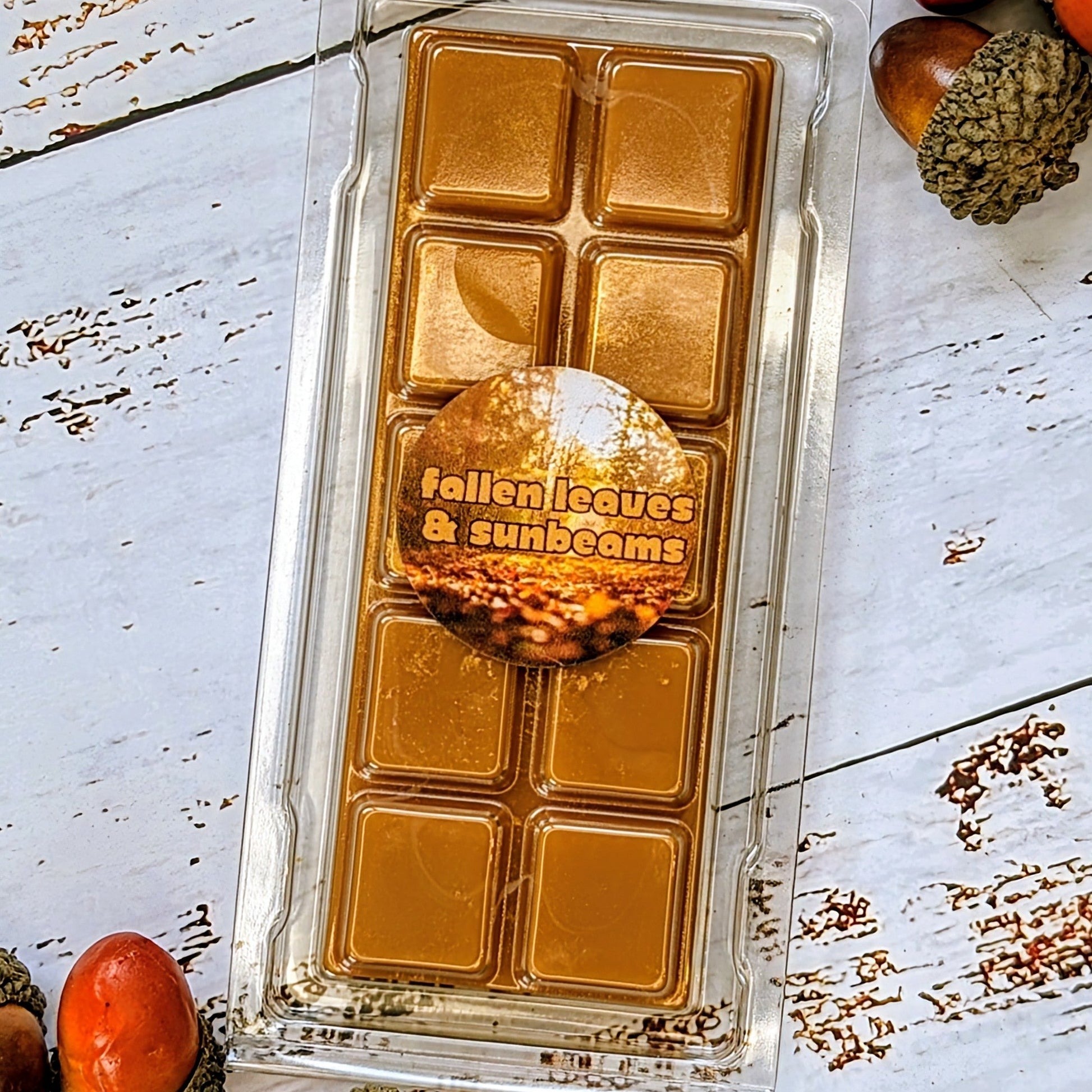 Fallen Leaves & Sunbeams coconut wax melt. Dark brown snap bar with gold shimmer accents.