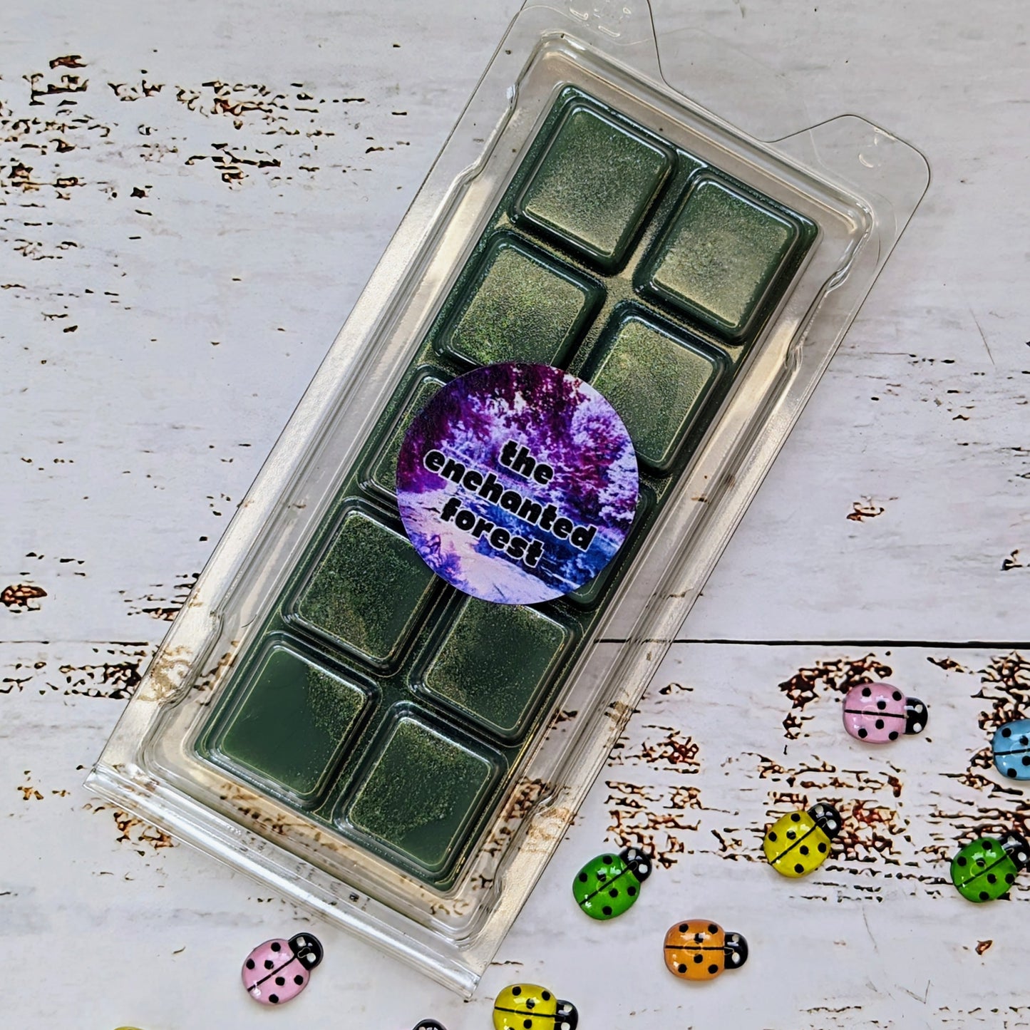 The Enchanted Forest coconut wax melt. Deep green snap bar with gold shimmer accent.