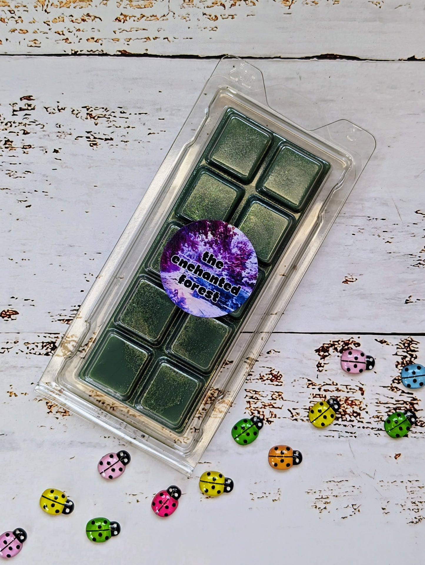 The Enchanted Forest coconut wax melt. Deep green snap bar with gold shimmer accent.