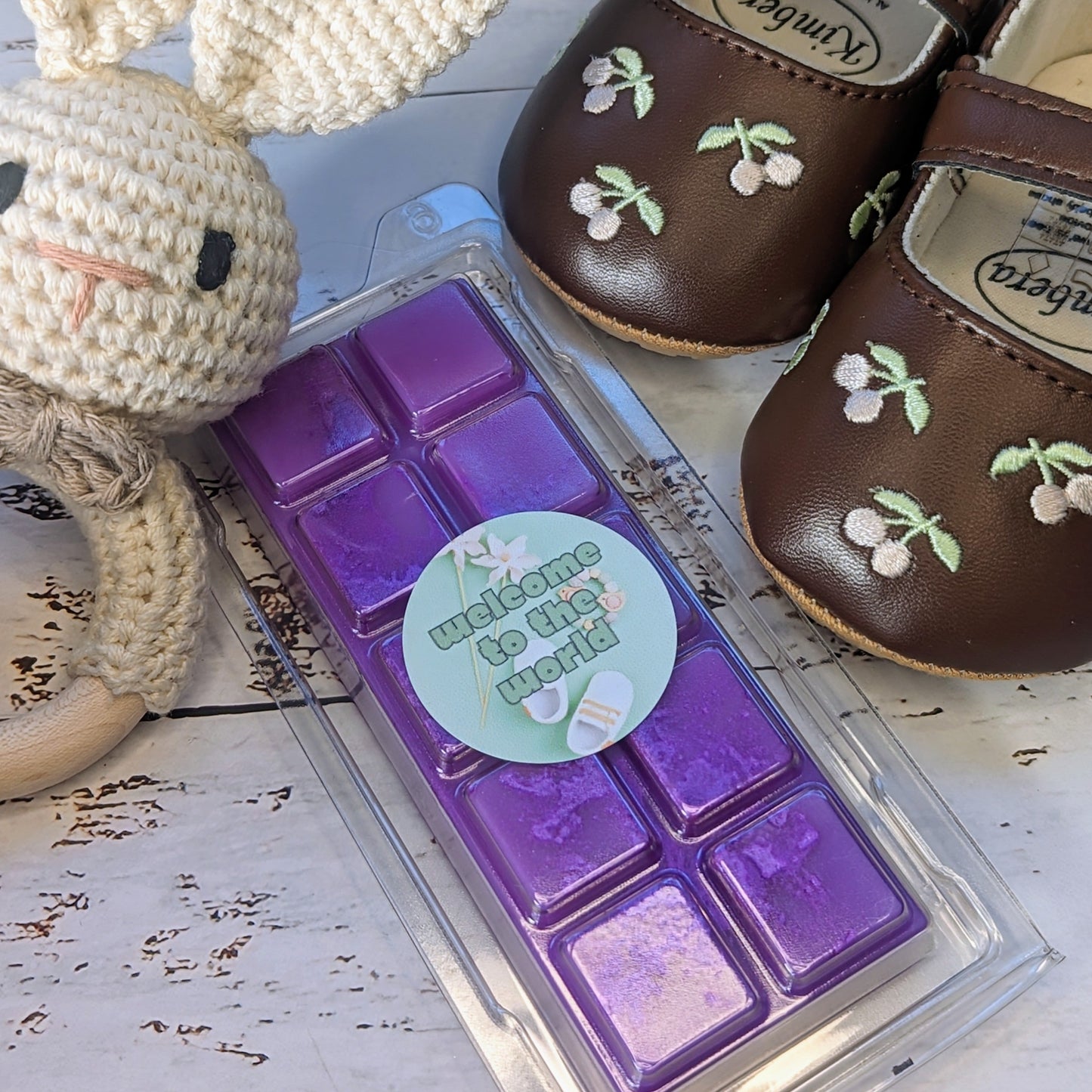 Welcome to the World coconut wax melt. Purple snap bar with purple shimmer accents.