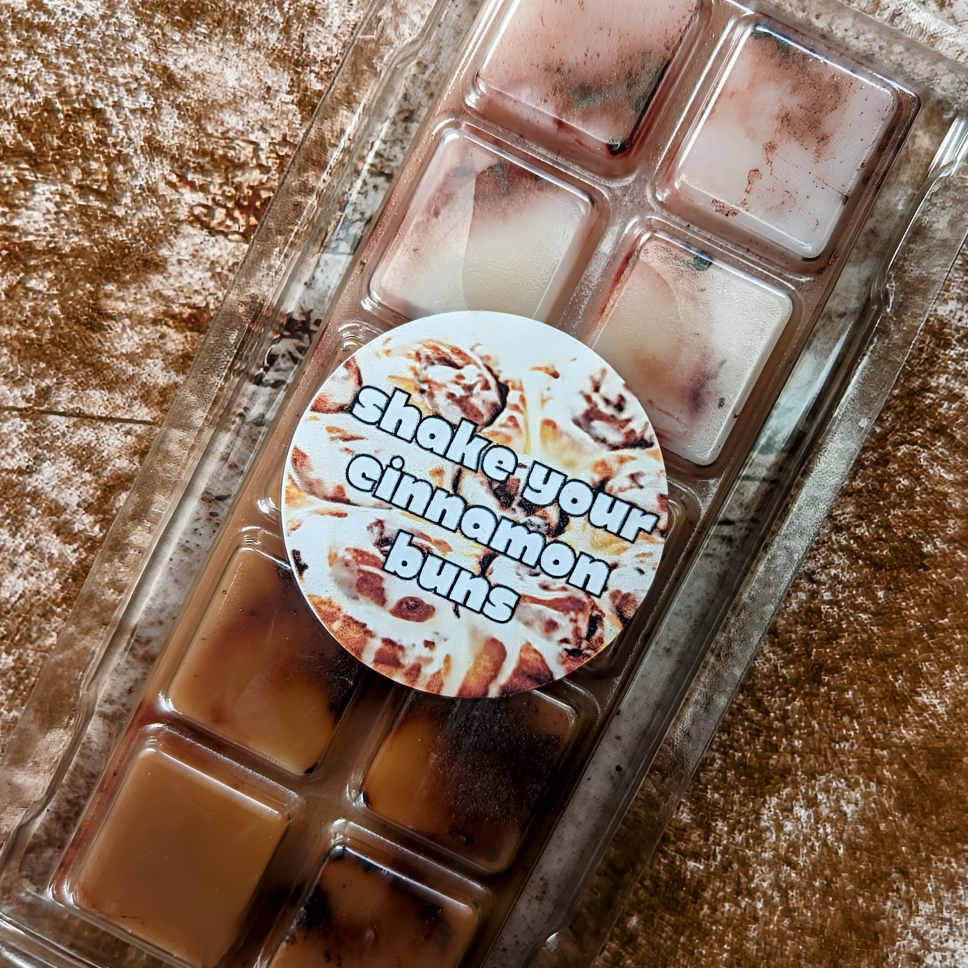 Shake Your Cinnamon Buns coconut wax melt. Deep brown snap bar with dark brown shimmer accents.