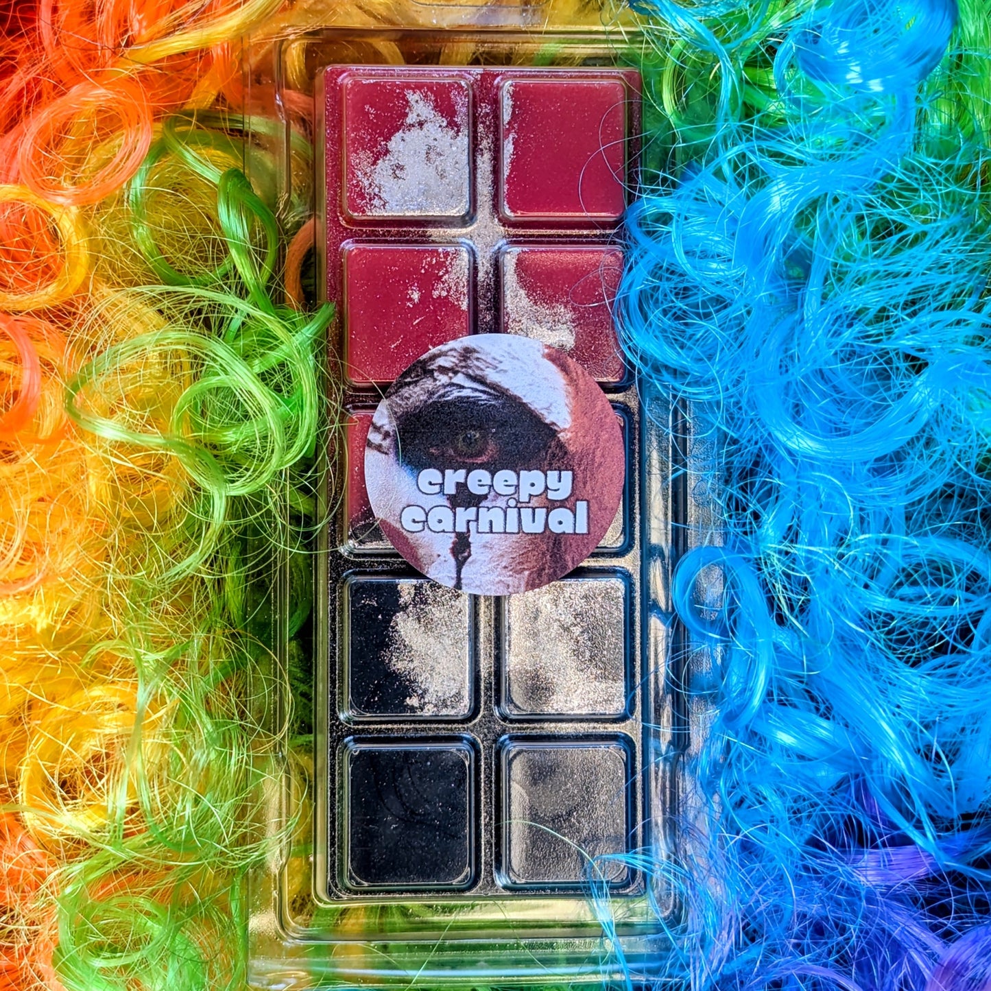 Creepy Carnival coconut wax melt. Navy and red ombre snap bar with silver shimmer accents. 