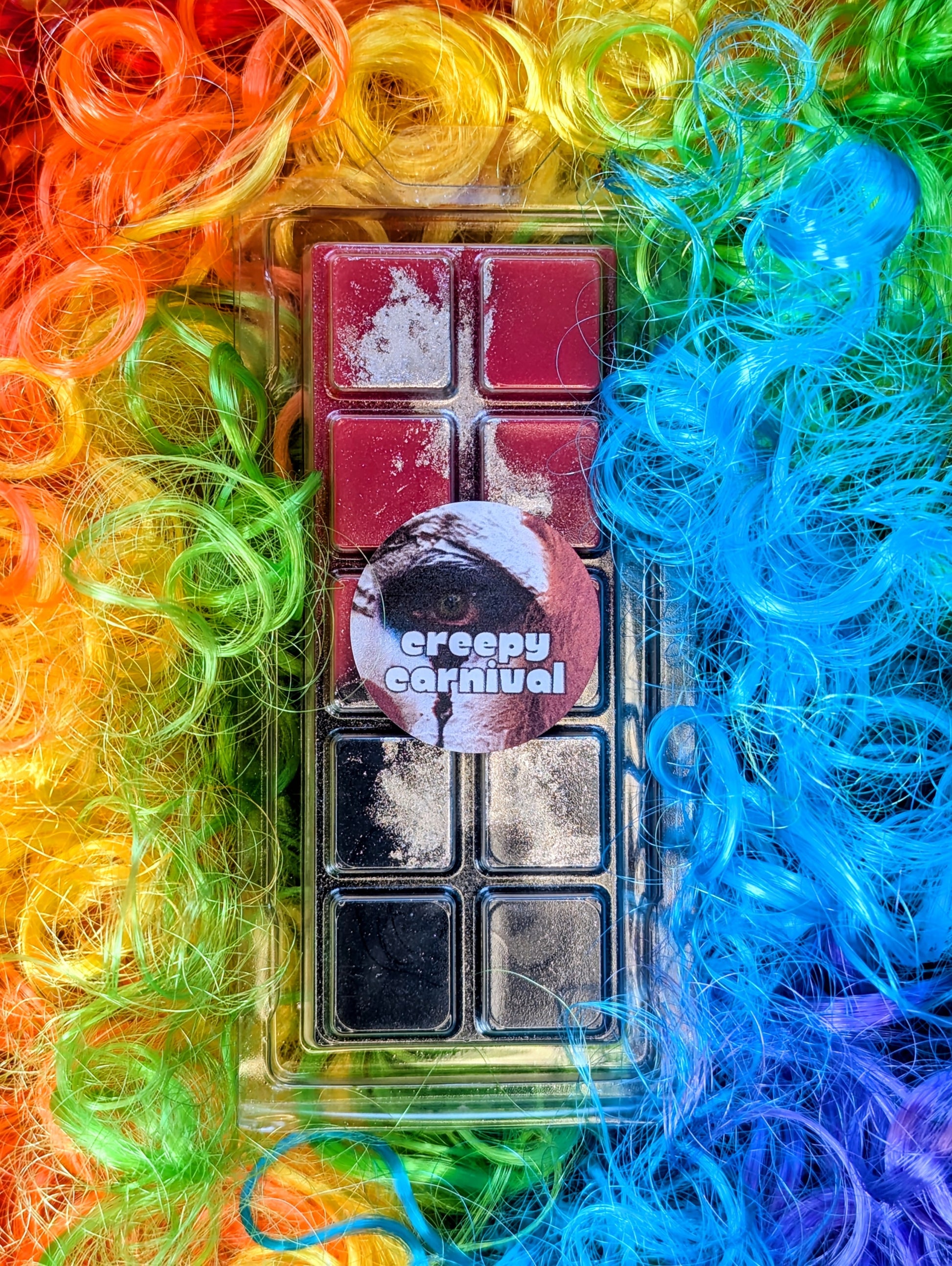 Creepy Carnival coconut wax melt. Navy and red ombre snap bar with silver shimmer accents. 