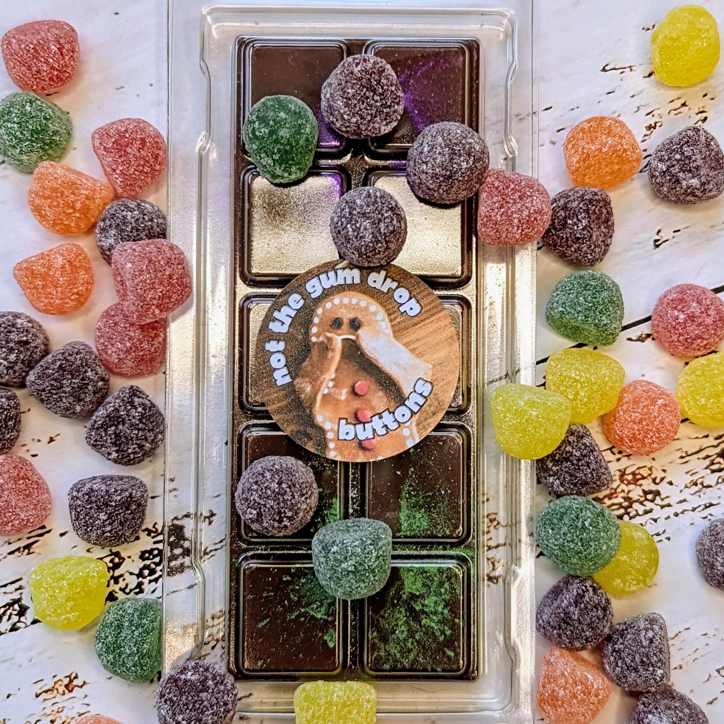 Not The Gumdrop Buttons coconut wax melt. Deep brown snap bar with purple and green shimmer accents.