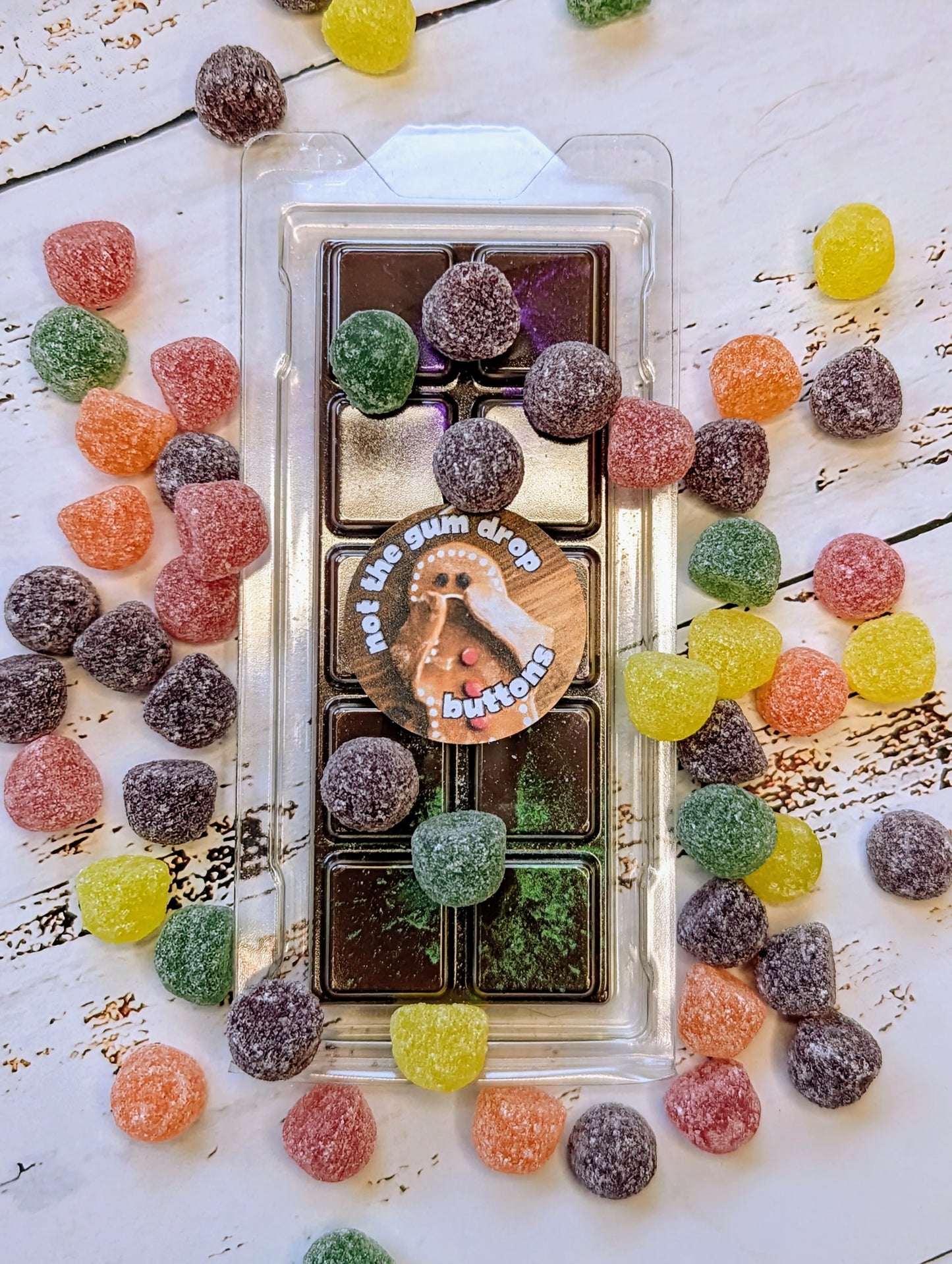 Not The Gumdrop Buttons coconut wax melt. Deep brown snap bar with purple and green shimmer accents.