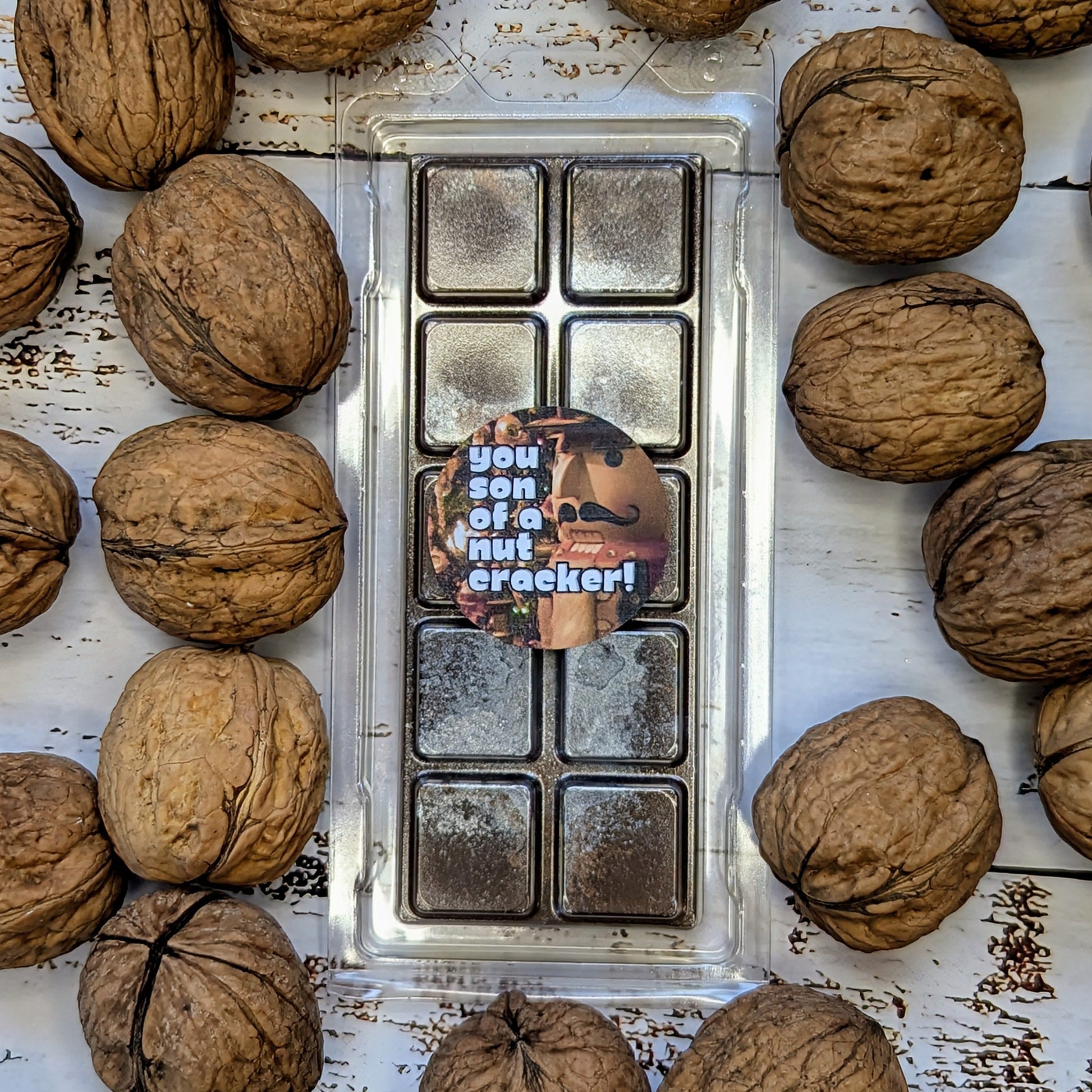 You Son Of A Nutcracker coconut wax melt. Dark brown snap bar with silver shimmer accents. 