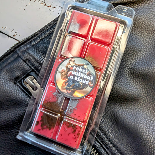 Rebel Without A Claus coconut wax melt. Bright red snap bar with bronze shimmer accents.
