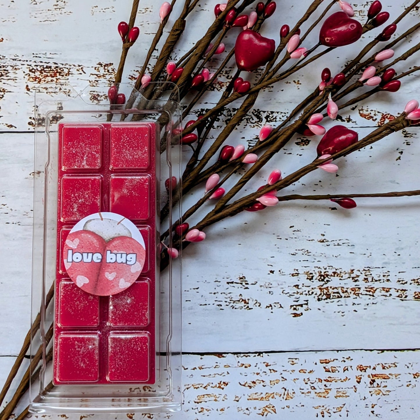 Love Bug coconut wax melt. Deep pink snap bar with silver shimmer accents.