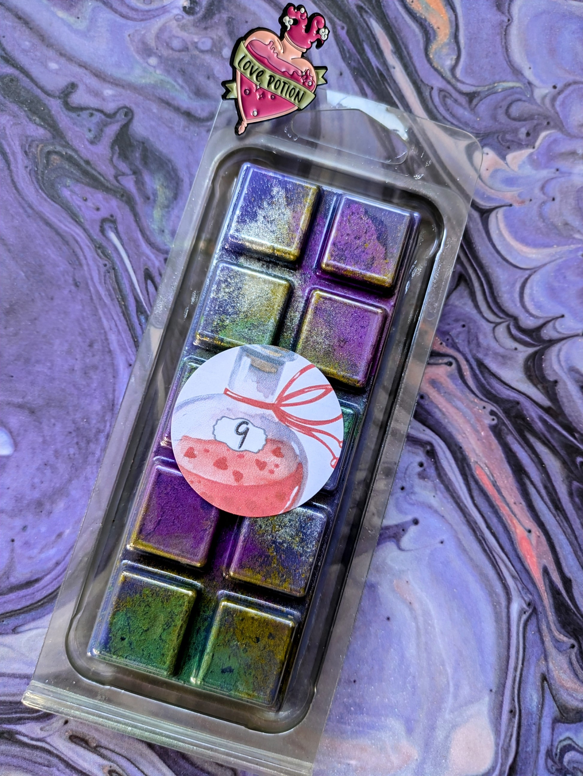 No. 9 coconut wax melt. Purple snap bar with green, gold and purple shimmer accents. 