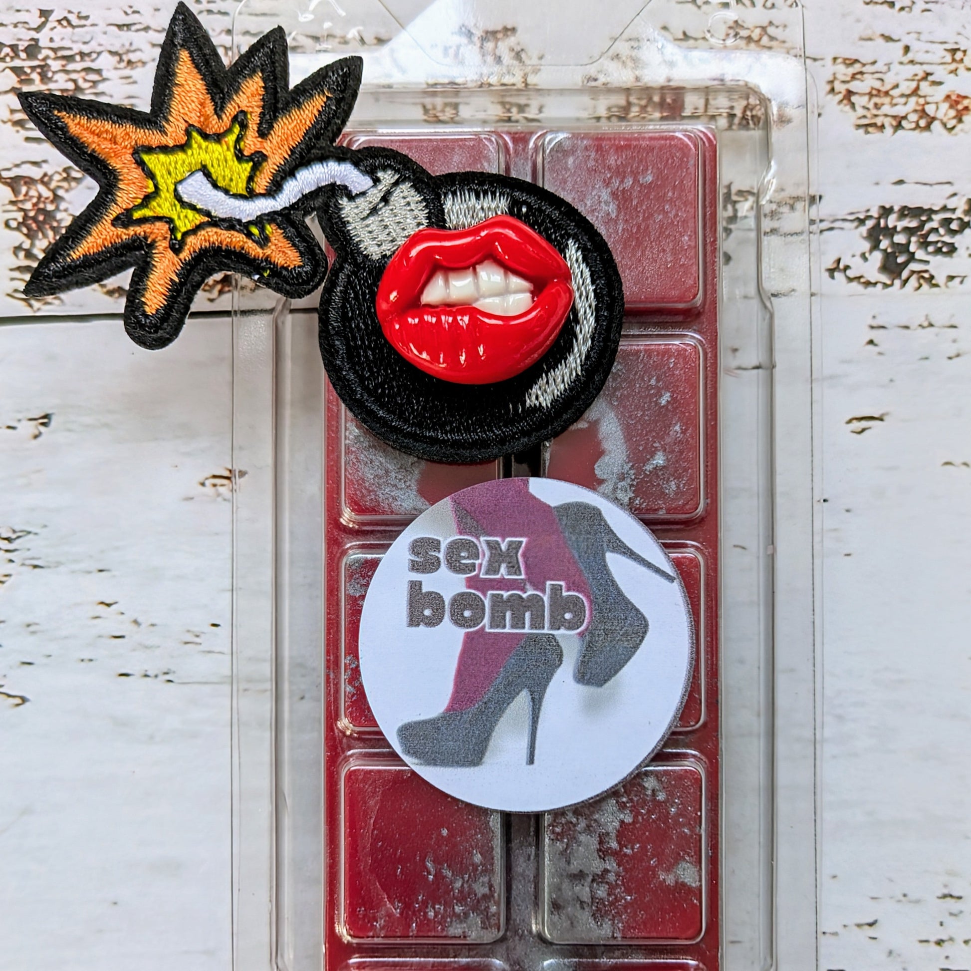 Sex Bomb coconut wax melt. Bright red snap bar with metallic grey shimmer accents. 