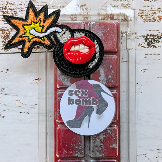Sex Bomb coconut wax melt. Bright red snap bar with metallic grey shimmer accents. 