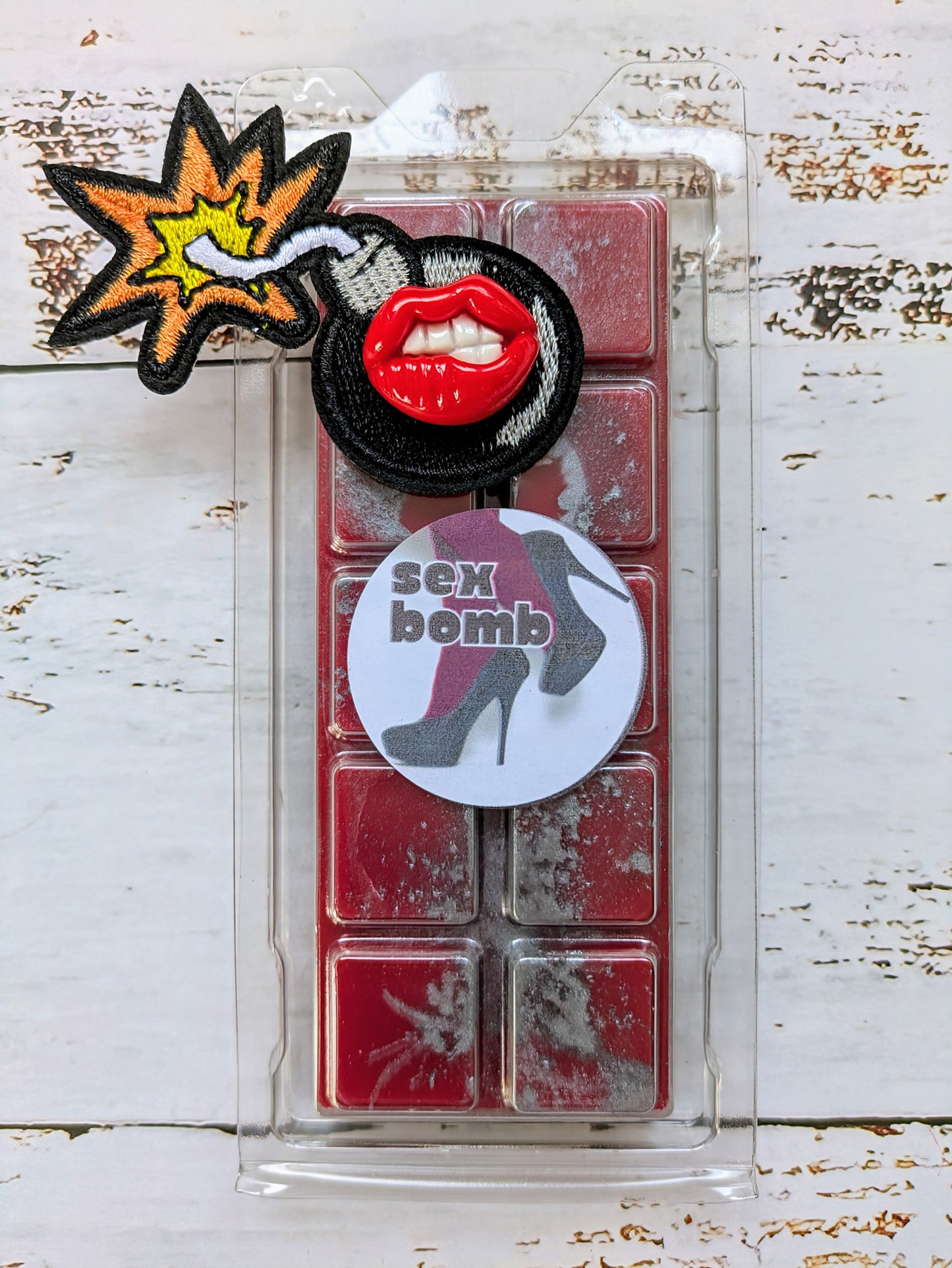 Sex Bomb coconut wax melt. Bright red snap bar with metallic grey shimmer accents. 