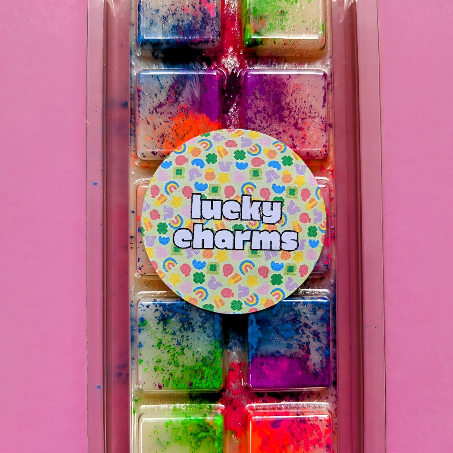 Lucky Charms coconut wax melt. Cream snap bar with green, blue, pink and orange shimmer accents.