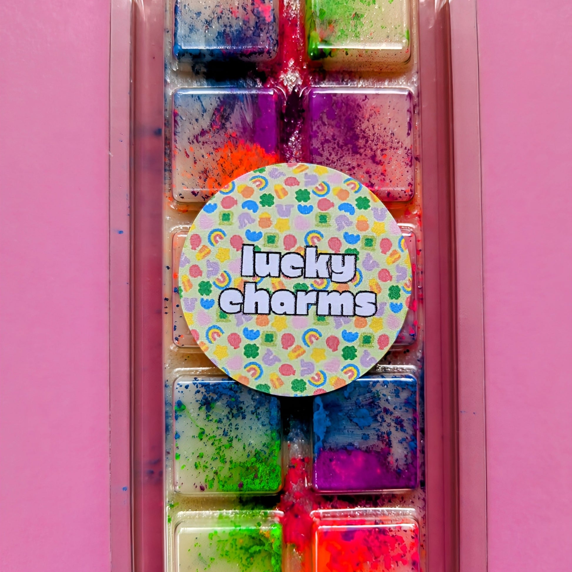 Lucky Charms coconut wax melt. Cream snap bar with green, blue, pink and orange shimmer accents.