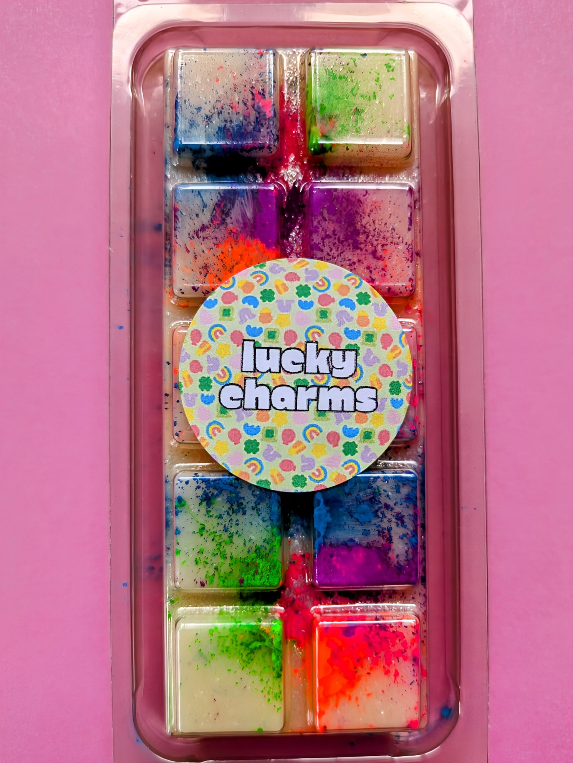 Lucky Charms coconut wax melt. Cream snap bar with green, blue, pink and orange shimmer accents.