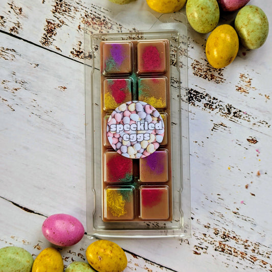 Speckled Eggs coconut wax melt. Dark brown snap bar with yellow, green, pink and purple shimmer accents.