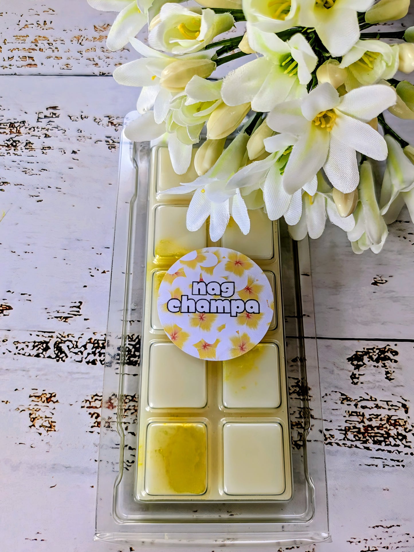 Nag Champa coconut wax melt. White snap bar with yellow and gold shimmer accents.