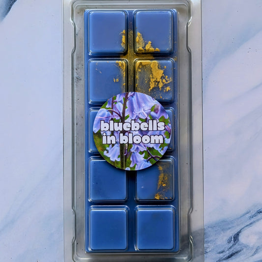 Bluebells in Bloom coconut wax melt. Deep blue snap bar with yellow and gold shimmer accents. 