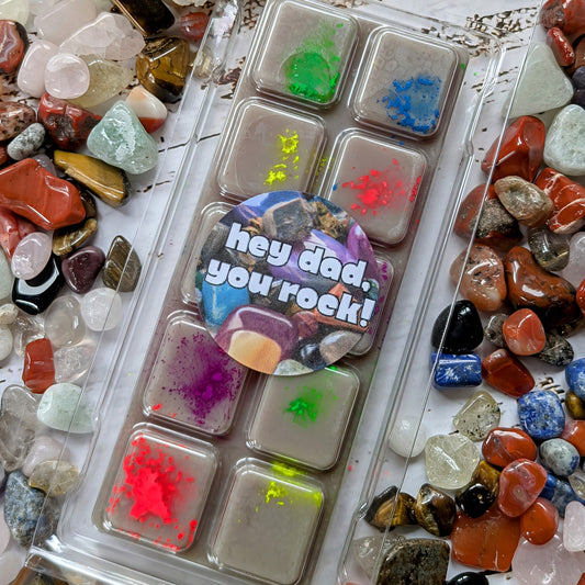 Hey Dad, You Rock! coconut wax melt. Grey snap bar with florescent green, blue, yellow, red and purple shimmer accents.