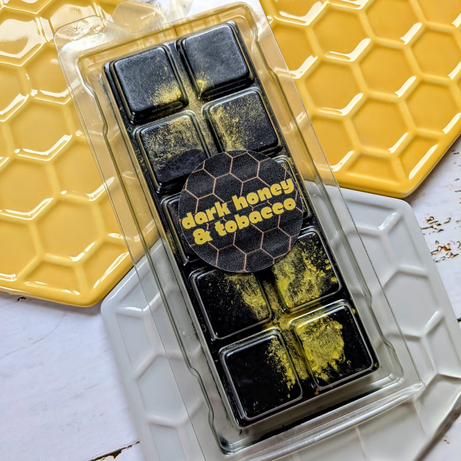 Dark Honey and Tobacco coconut wax melt. Black snap bar with fluorescent yellow shimmer accents. 